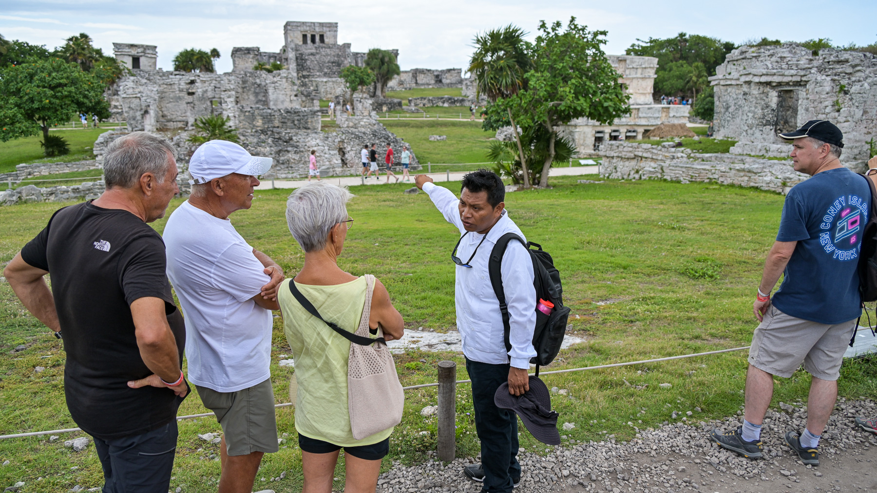 A guide explains the Mayan ruins in Tulum